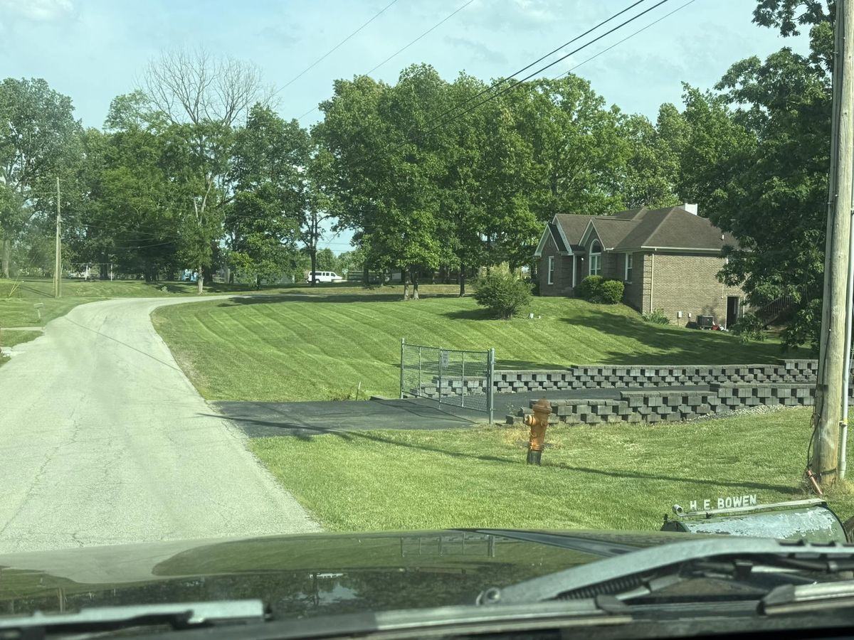 A gated larger property seen through the windshield on the way in